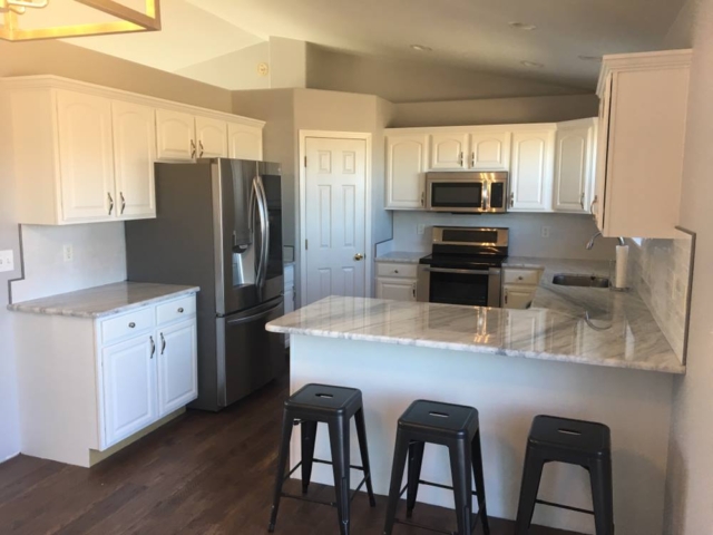 Photo of Kitchen cabinet refinishing: custom painting project.