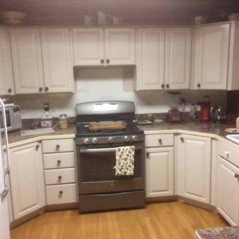 Photo of Kitchen cabinet refinishing: custom painting project.